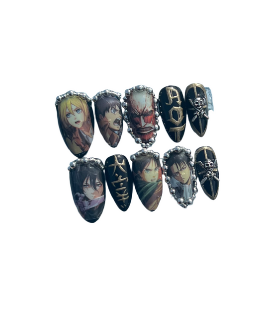 A set of press on nails featuring characters from the anime Attack On Titan
